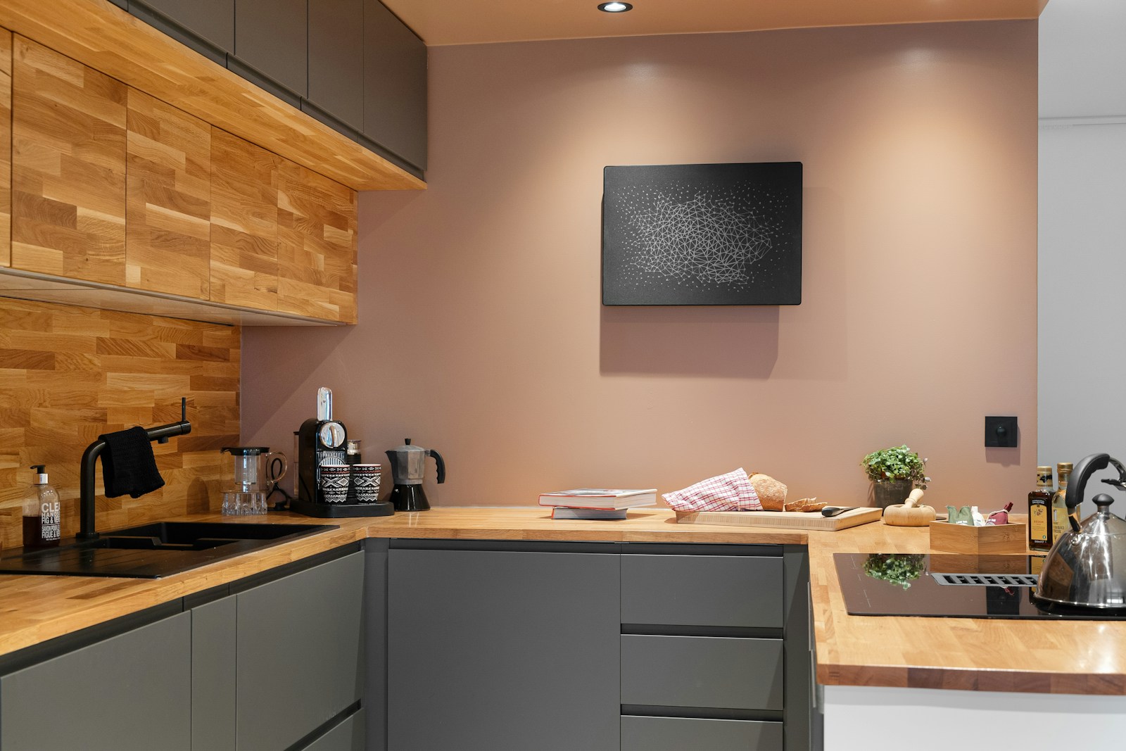 A kitchen with a wooden counter top next to a stove top oven